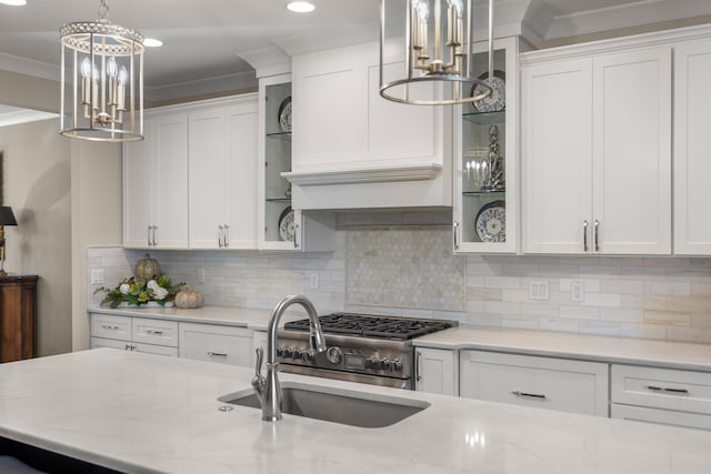 kitchen with white cabinets, decorative light fixtures, decorative backsplash, and sink