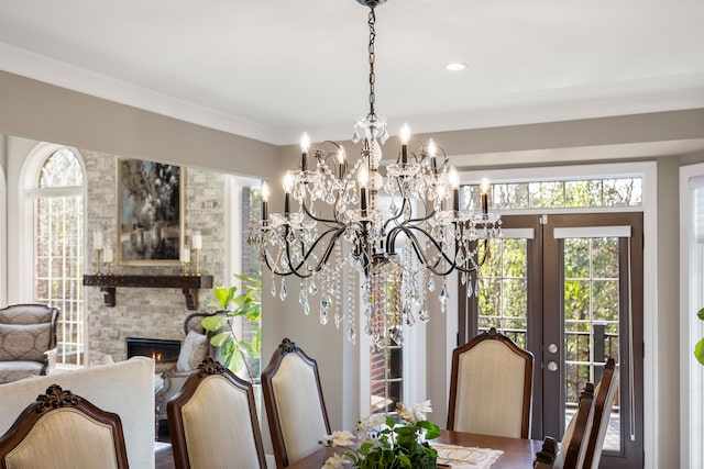 dining space featuring a fireplace and crown molding