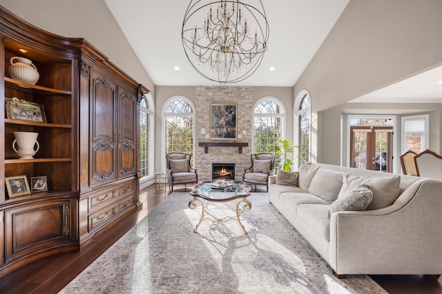 living room featuring dark hardwood / wood-style flooring, a healthy amount of sunlight, and vaulted ceiling