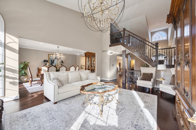 living room featuring a notable chandelier, dark hardwood / wood-style flooring, ornamental molding, and high vaulted ceiling