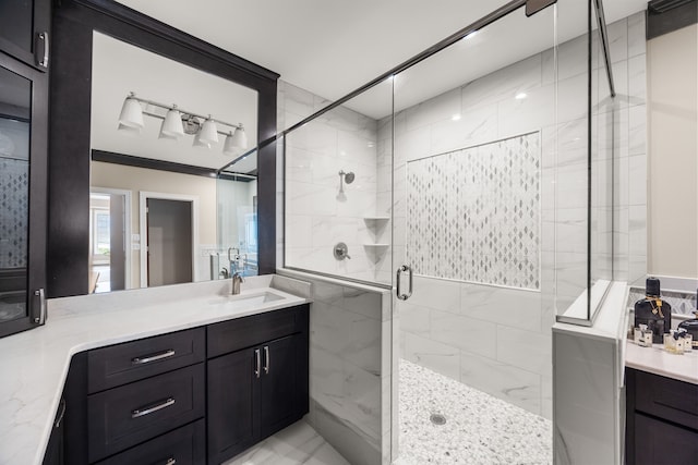 bathroom with vanity, an enclosed shower, tile walls, and crown molding