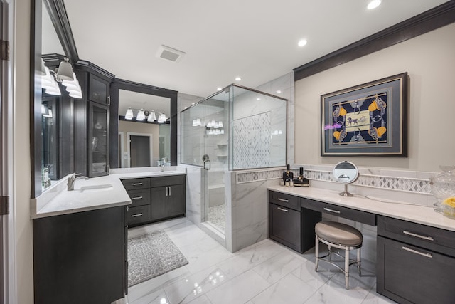 bathroom with vanity, a shower with shower door, and ornamental molding