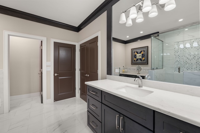 bathroom featuring vanity, a shower with shower door, and ornamental molding