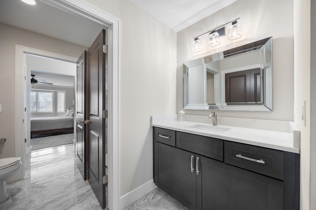 bathroom featuring vanity, toilet, and ceiling fan