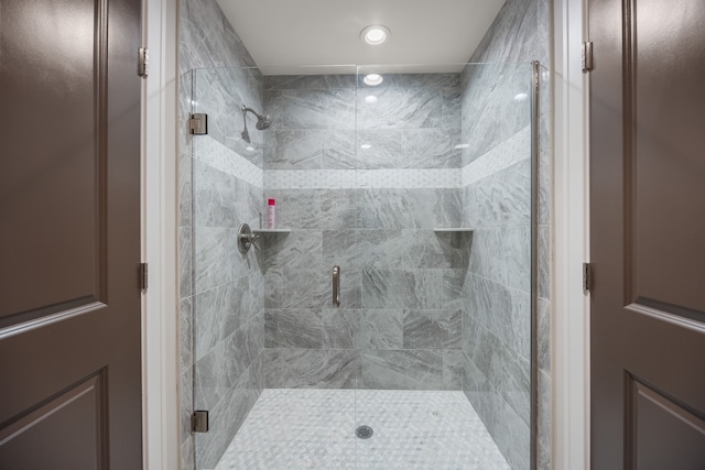 bathroom featuring a shower with shower door