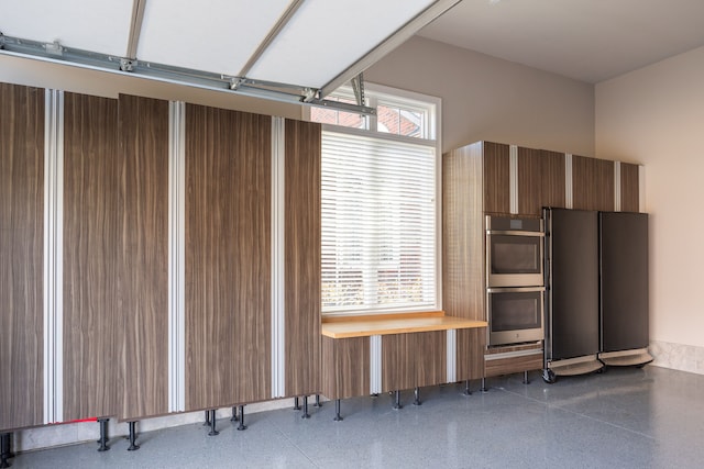 garage with stainless steel refrigerator