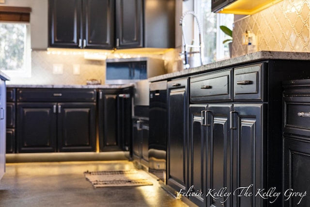 kitchen with plenty of natural light and dark stone counters