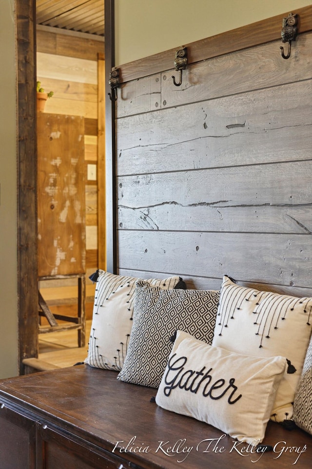 mudroom featuring hardwood / wood-style floors, wood walls, and wood ceiling