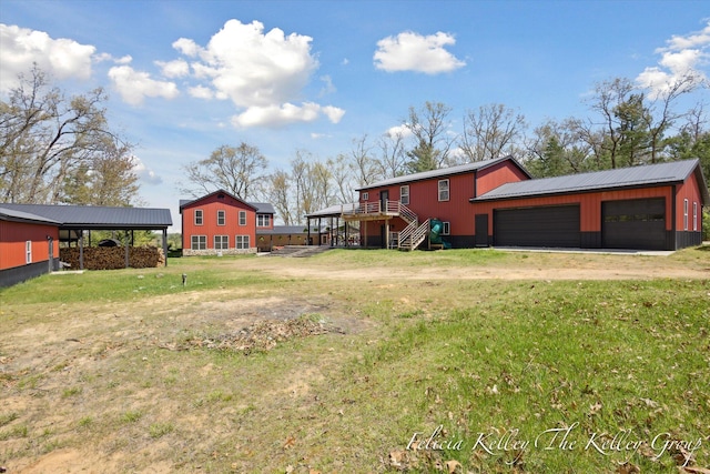 view of yard with an outbuilding, a carport, and a garage