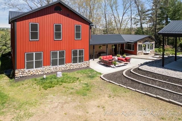 back of house featuring a patio area and an outdoor hangout area