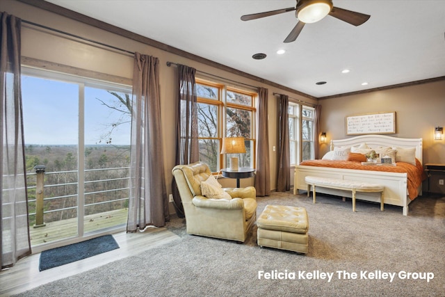 bedroom featuring ceiling fan, ornamental molding, and multiple windows