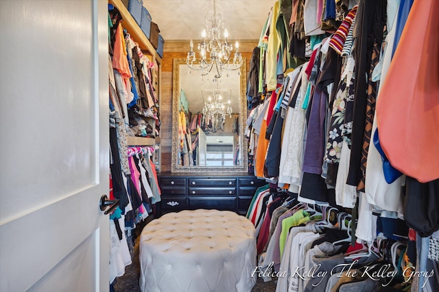 spacious closet featuring a chandelier