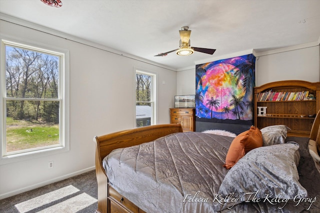 bedroom featuring multiple windows, ceiling fan, and carpet