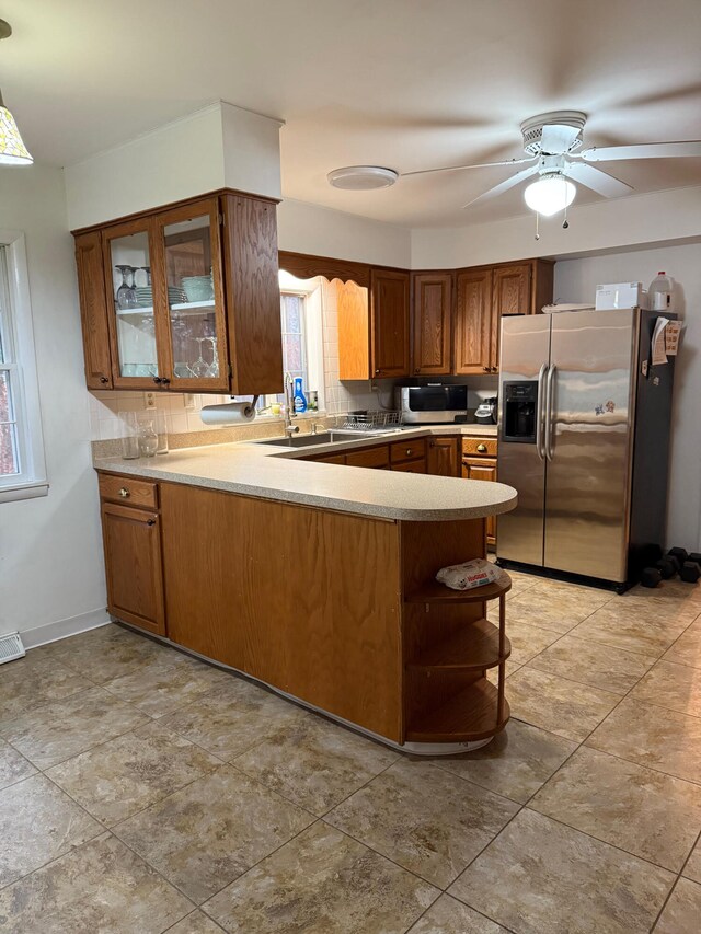 kitchen featuring ceiling fan, kitchen peninsula, and stainless steel appliances