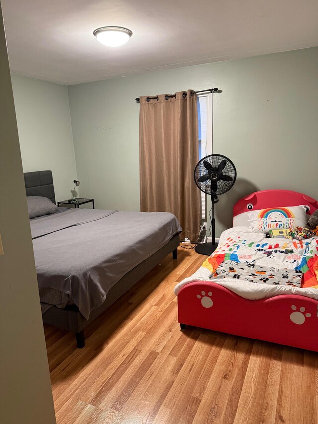 bedroom with hardwood / wood-style flooring