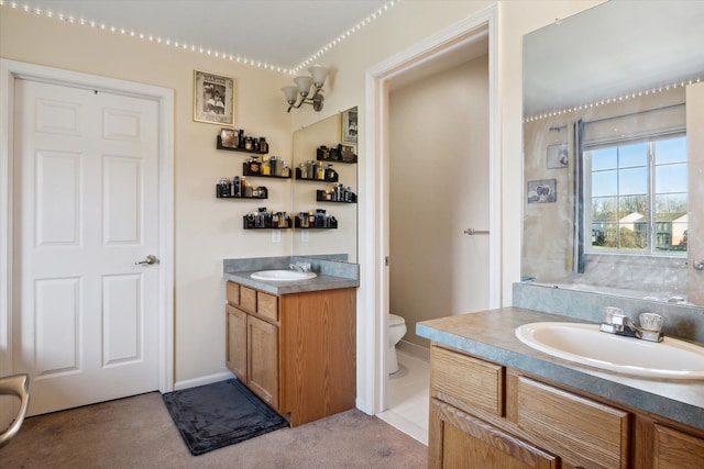 bathroom featuring vanity, toilet, and a notable chandelier