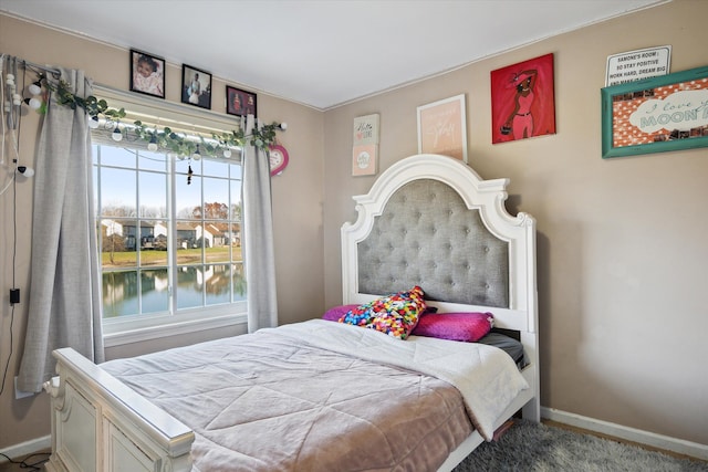 bedroom featuring a water view