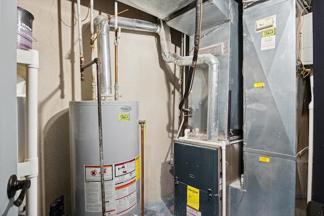 utility room featuring gas water heater and heating unit