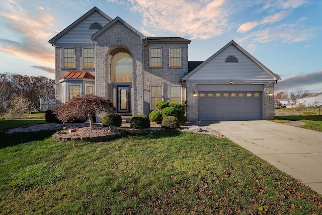 view of front facade with a garage and a yard