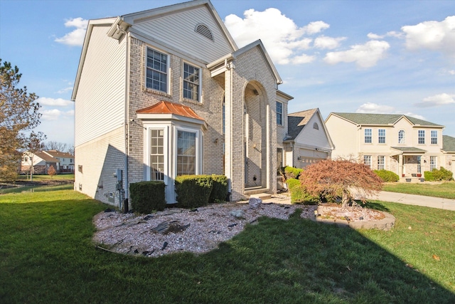 view of front of house featuring a front yard and a garage