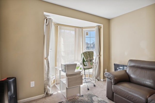 sitting room featuring light colored carpet