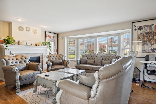 living room featuring dark hardwood / wood-style floors and a tiled fireplace