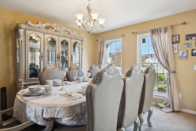 dining area featuring a notable chandelier and carpet floors