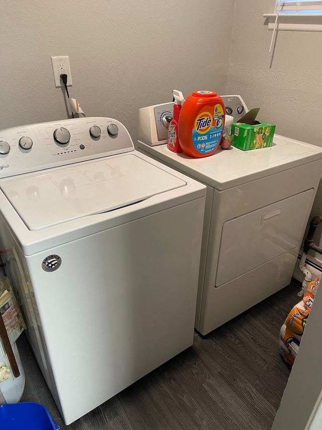 clothes washing area featuring separate washer and dryer and dark wood-type flooring