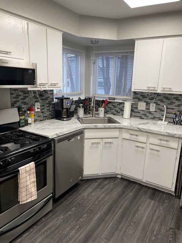 kitchen with white cabinets, dark hardwood / wood-style flooring, stainless steel appliances, and sink