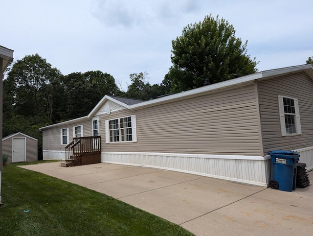 exterior space with a lawn, a storage shed, and a patio