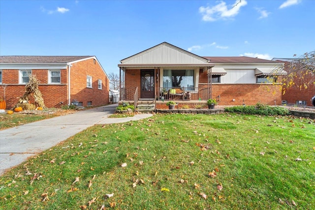 view of front of property with covered porch and a front lawn