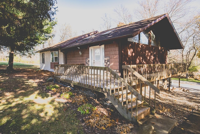 view of side of home with a wooden deck