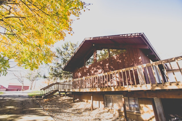 view of side of property featuring a wooden deck