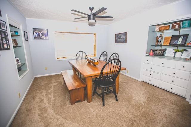 dining space with light carpet, a textured ceiling, and ceiling fan