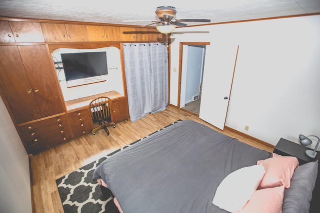 bedroom with light hardwood / wood-style flooring, ceiling fan, and crown molding