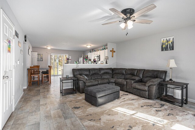 living room with ceiling fan and hardwood / wood-style flooring