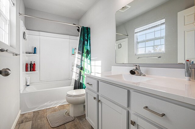 full bathroom featuring toilet, vanity, shower / bath combination with curtain, and hardwood / wood-style flooring