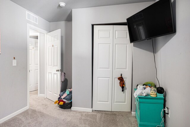 carpeted bedroom featuring a closet