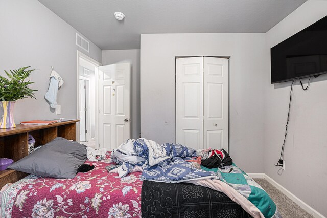 carpeted bedroom featuring a closet