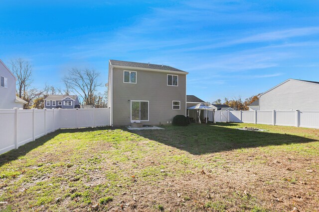 rear view of house with a yard