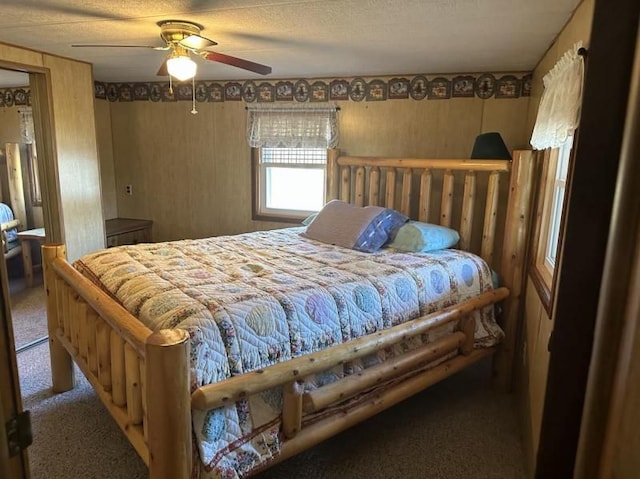 carpeted bedroom featuring a textured ceiling and ceiling fan