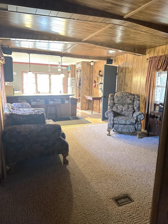 2965 Pointe Aux Barques Rd, Port Austin, MI 48467 - carpeted living room featuring wood ceiling and wooden walls