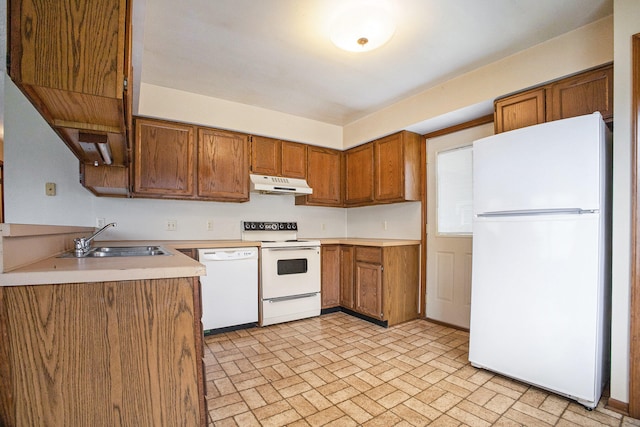 kitchen featuring sink and white appliances