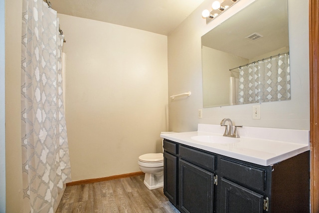 bathroom with hardwood / wood-style floors, vanity, and toilet