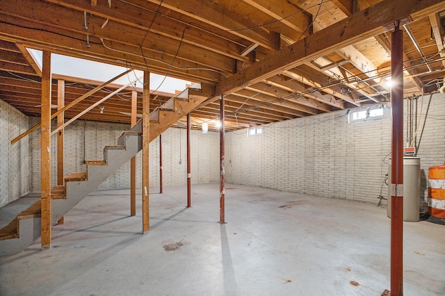 basement featuring brick wall