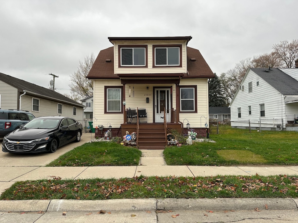 bungalow-style home with a porch and a front lawn