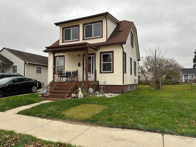 view of front facade featuring a front yard and a porch