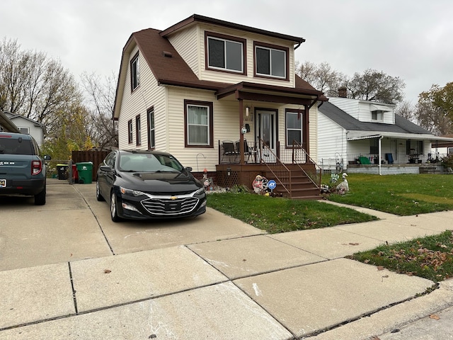 view of front of property featuring covered porch and a front lawn