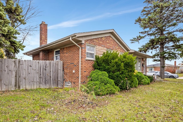 view of home's exterior with a yard