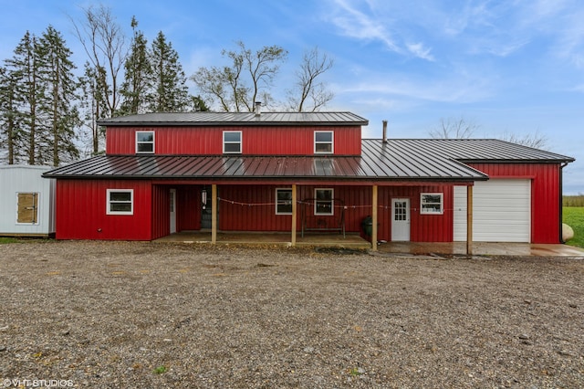 back of property featuring a garage